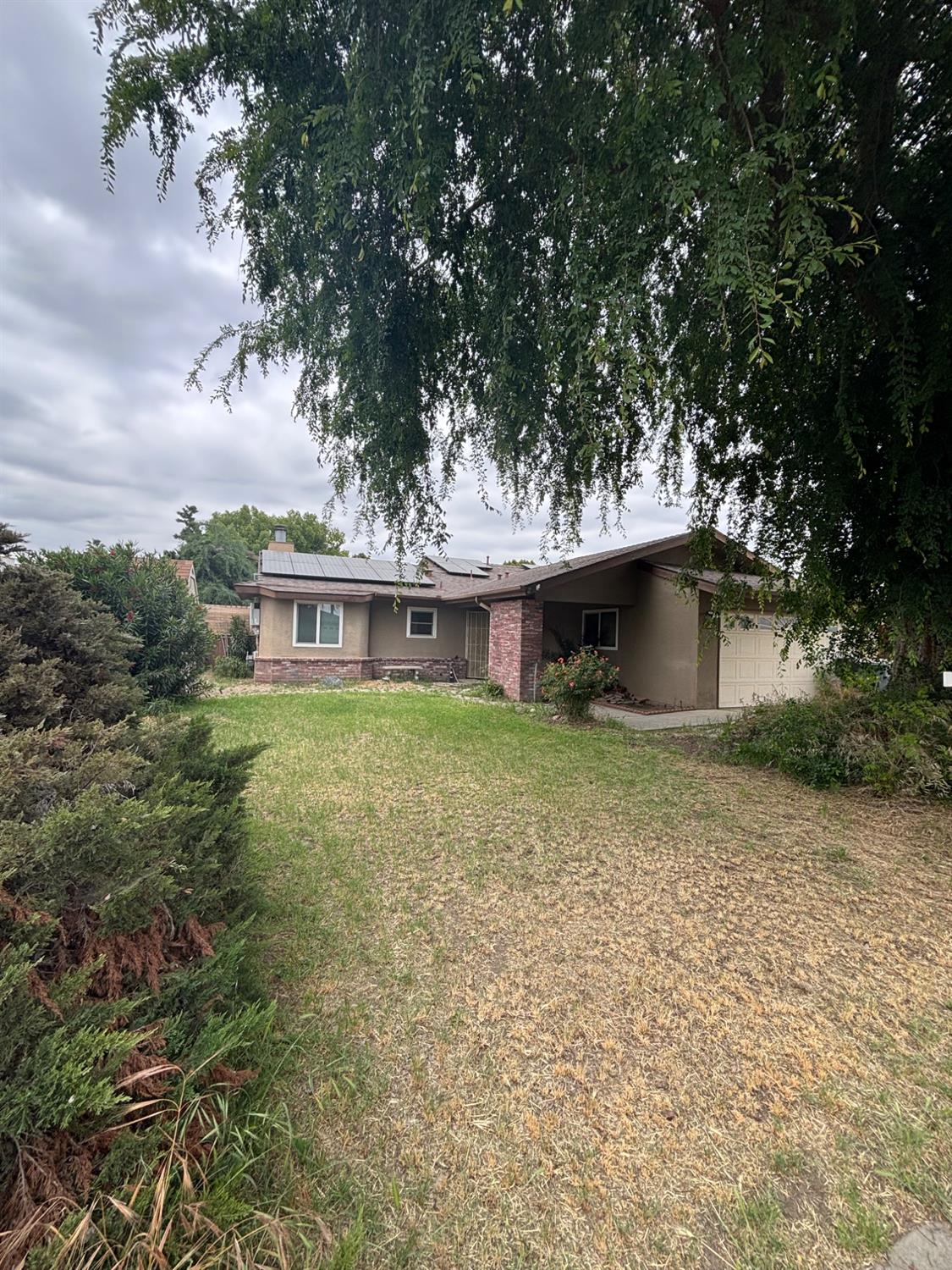 a front view of a house with a garden