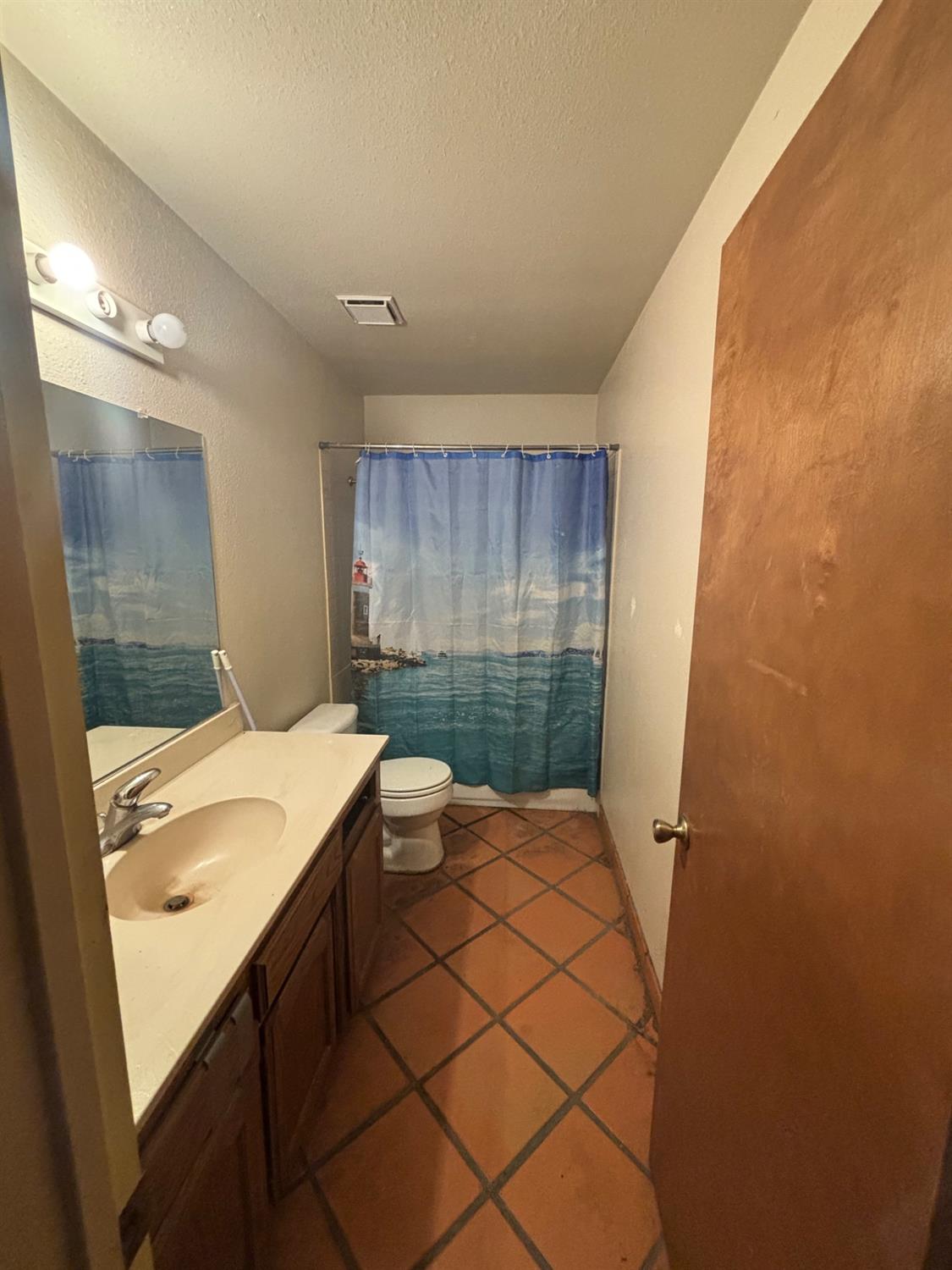 1225 Pontiac Avenue Clovis, CA 93727 - Photo 15 of 18 a bathroom with a sink and a shower