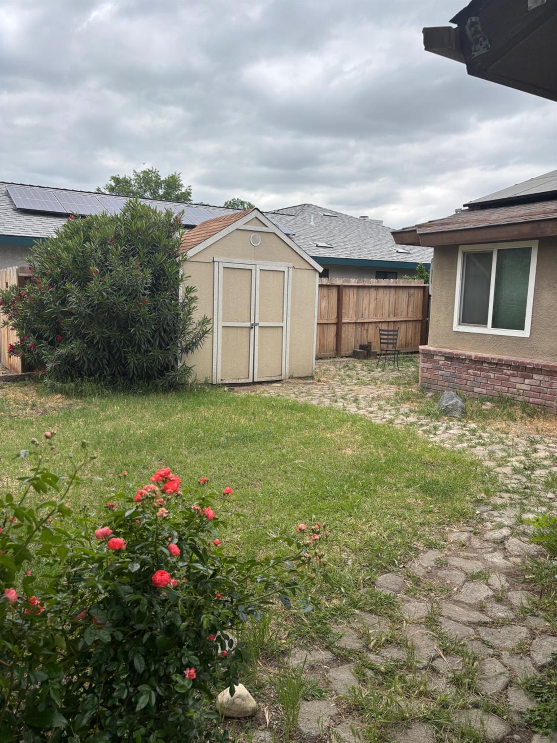 1225 Pontiac Avenue Clovis, CA 93727 - Photo 2 of 18 a view of a house with a big yard and potted plants