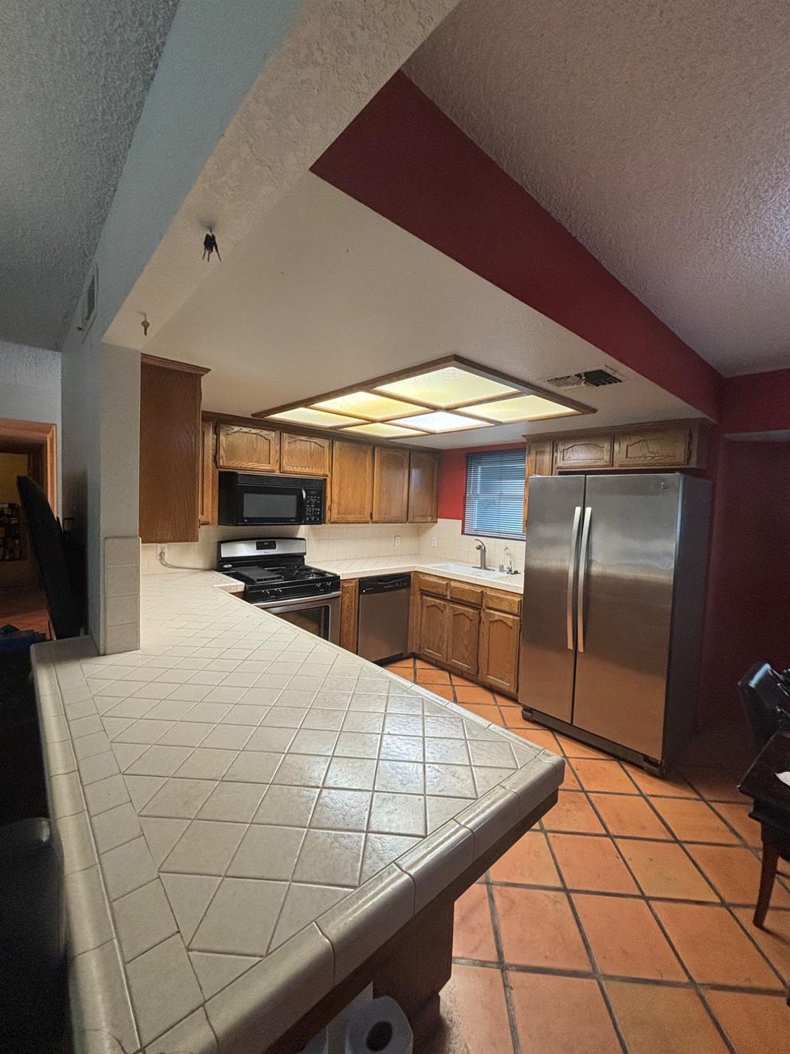 1225 Pontiac Avenue Clovis, CA 93727 - Photo 7 of 18 a kitchen with stainless steel appliances kitchen island granite countertop a sink and white cabinets