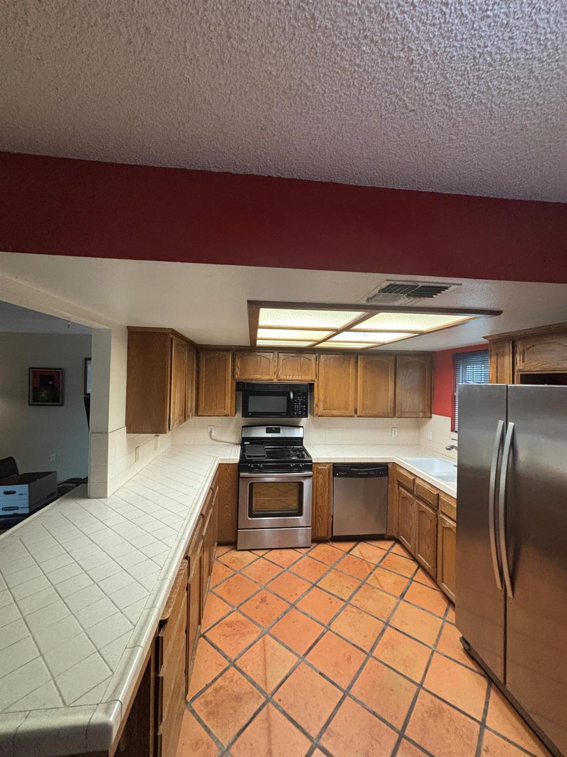 1225 Pontiac Avenue Clovis, CA 93727 - Photo 8 of 18 a kitchen with stainless steel appliances a sink and a refrigerator