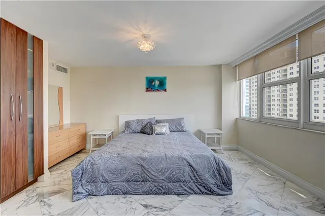 a bedroom with a large bed and a window