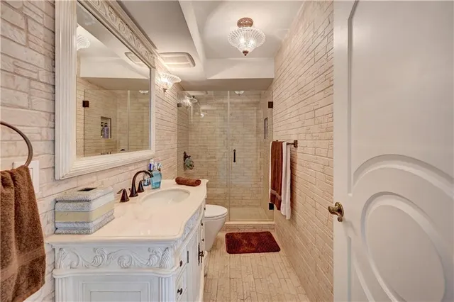 a bathroom with a sink vanity granite tub and shower