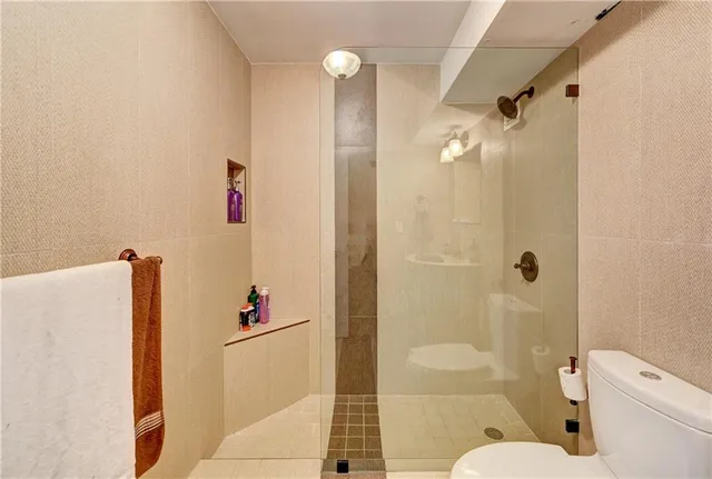 a utility room with granite countertop cabinets washer and dryer