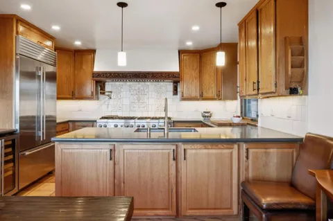 a bathroom with a sink a toilet a mirror and shower