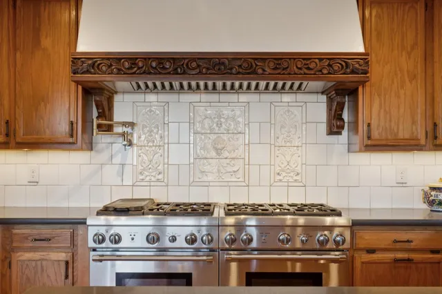 a view of a patio with table and chairs potted plants and large tree