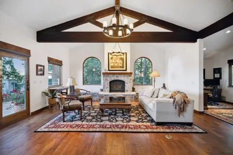 a bedroom with furniture and a wooden floor