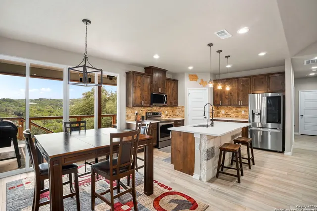 a dining room with furniture a chandelier and wooden floor