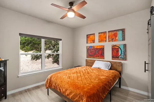 a bed sitting in a bedroom next to a window