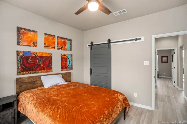 a bedroom with a bed and a chandelier