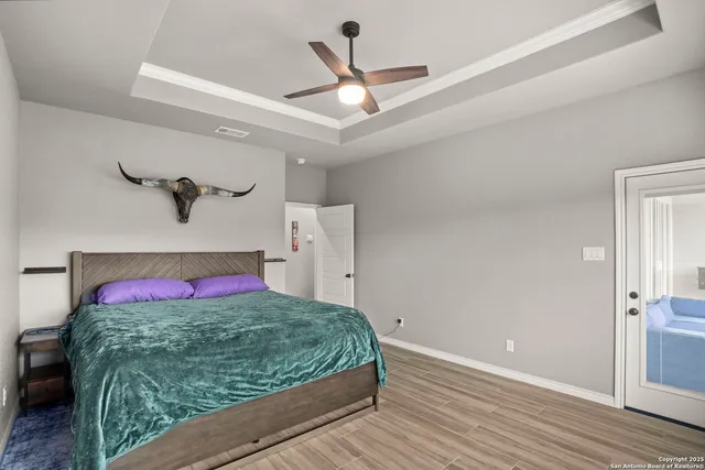 a bedroom with a bed chandelier and a window
