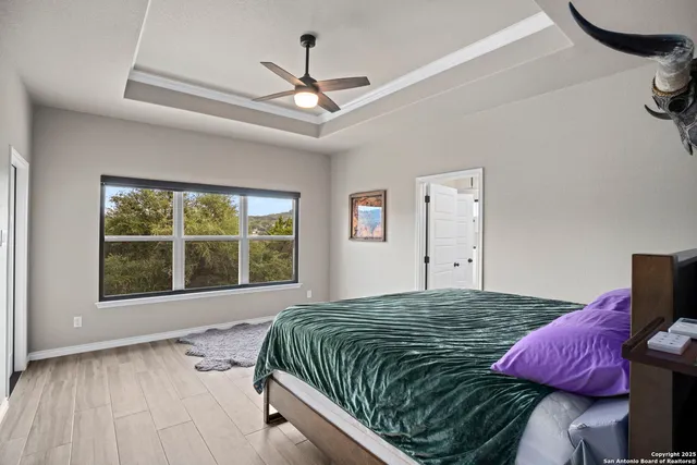 a bedroom with a large bed and a large window