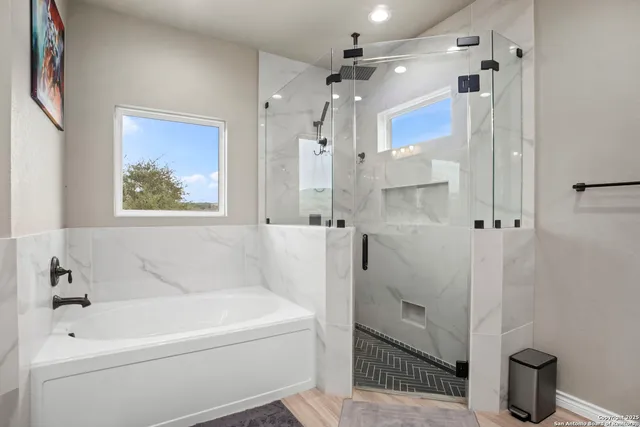 a bathroom with a bathtub a toilet and a shower