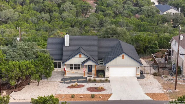 an aerial view of a house with a yard
