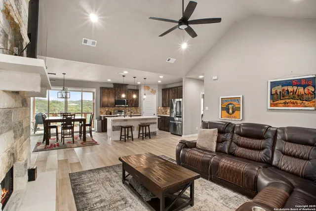 a living room with furniture and kitchen view