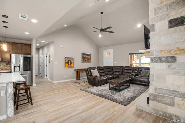 a living room with furniture and wooden floor