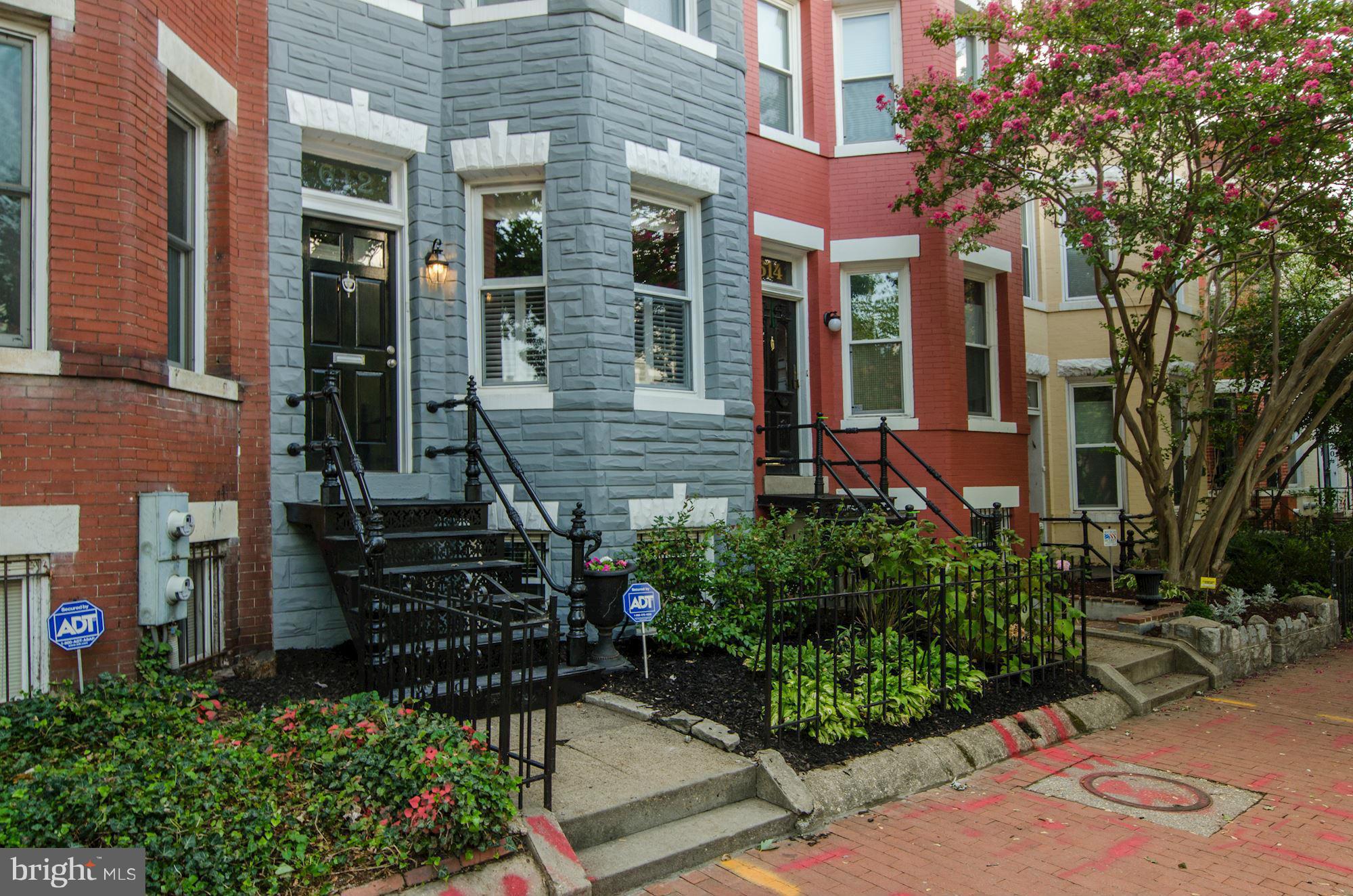 612 4th Street Northeast Washington, DC 20002 - Photo 2 of 28 front view of a brick house with a yard