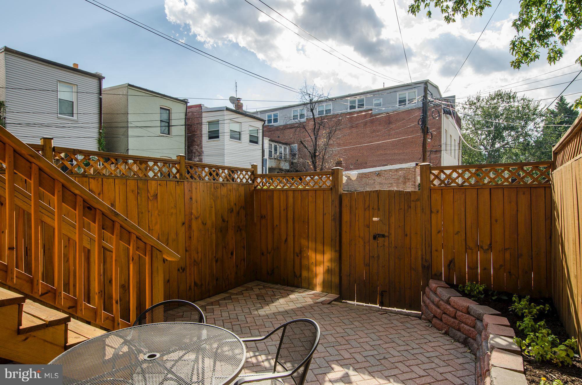 612 4th Street Northeast Washington, DC 20002 - Photo 13 of 28 a backyard of a house with table and chairs