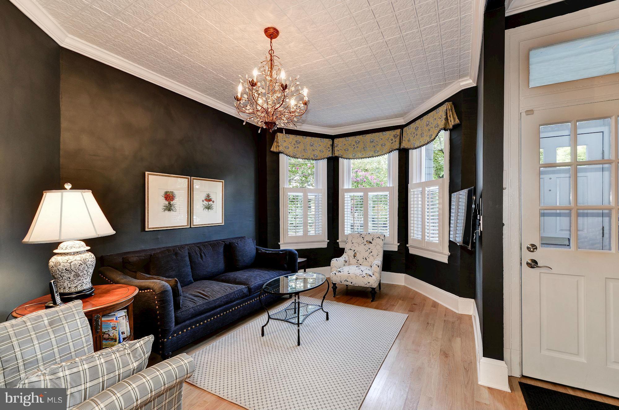 612 4th Street Northeast Washington, DC 20002 - Photo 3 of 28 a living room with furniture and a chandelier