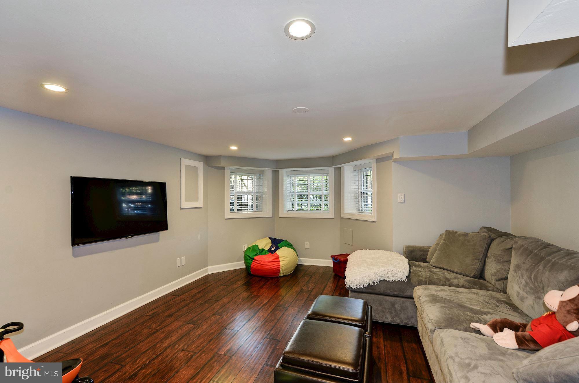 612 4th Street Northeast Washington, DC 20002 - Photo 22 of 28 a living room with furniture and a flat screen tv