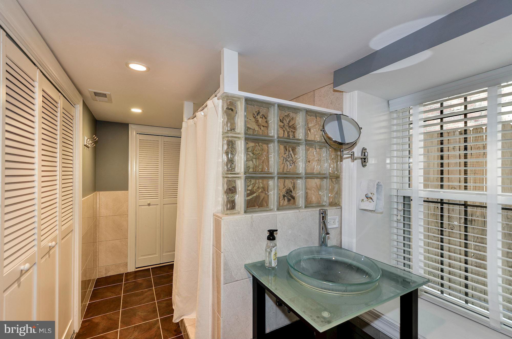 612 4th Street Northeast Washington, DC 20002 - Photo 25 of 28 a bathroom with a sink and a mirror