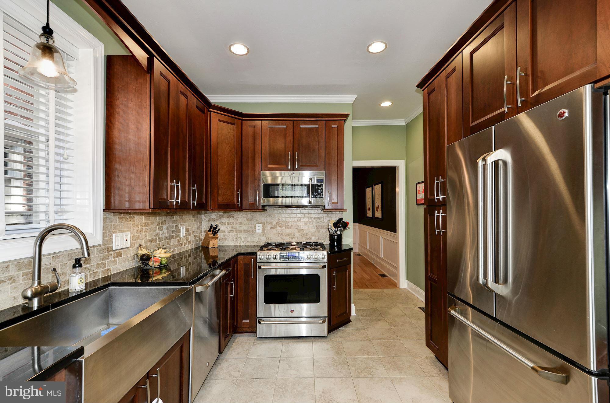 612 4th Street Northeast Washington, DC 20002 - Photo 9 of 28 a kitchen with stainless steel appliances granite countertop a refrigerator a sink and a stove