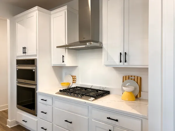 a kitchen with stainless steel appliances granite countertop a stove and a refrigerator