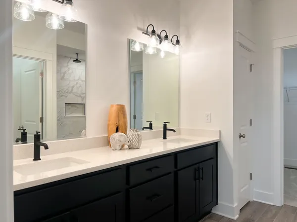 a bathroom with a double vanity sink and a mirror