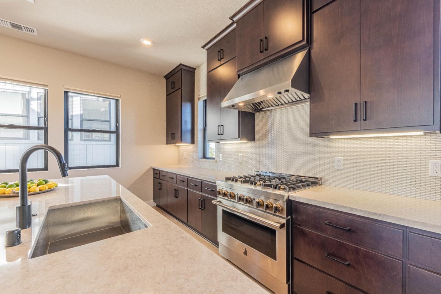 135 8th Street Marina, CA 93933 - Photo 33 of 69 a kitchen with stainless steel appliances granite countertop a stove and a sink