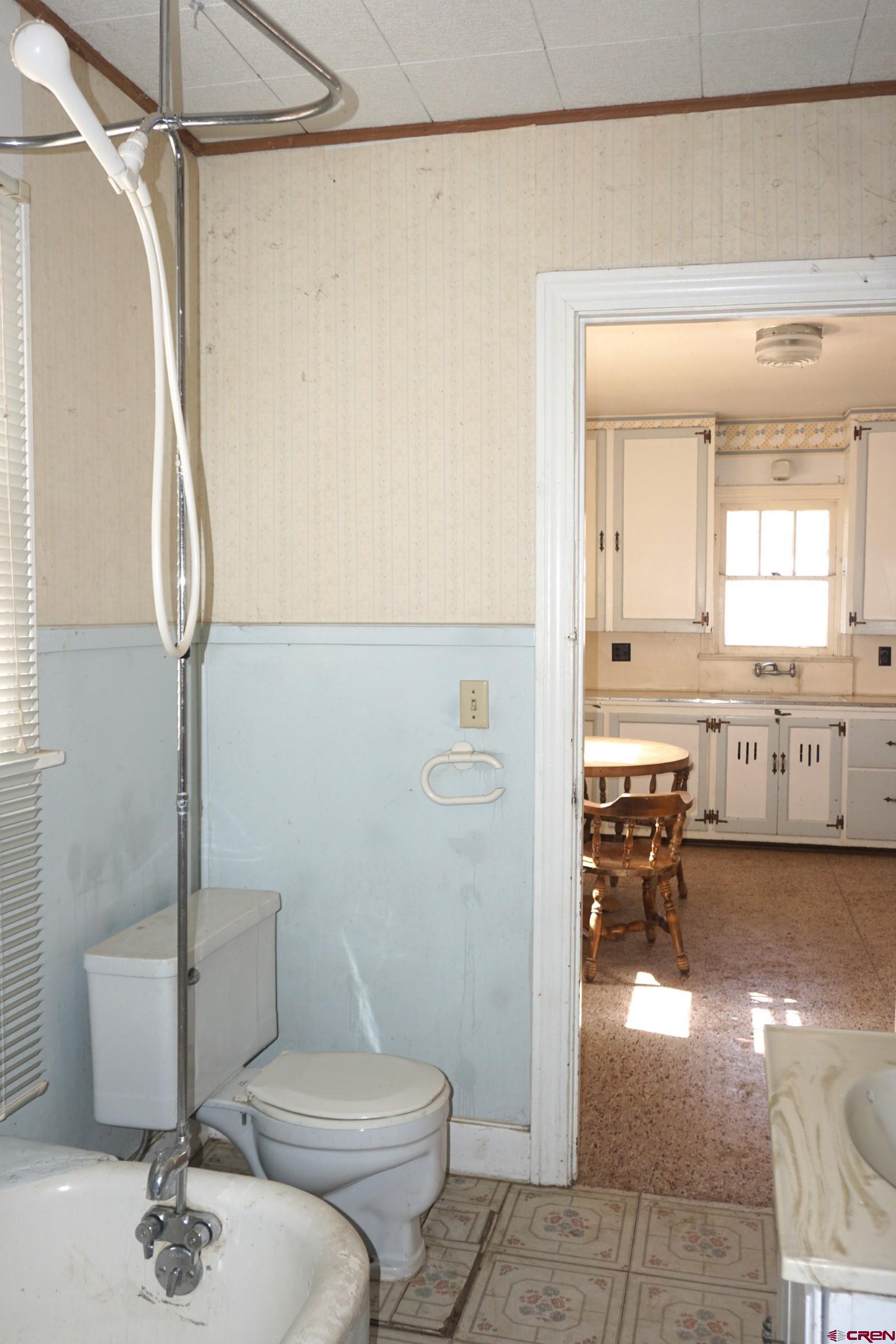 19235 2325th Road Cedaredge, CO 81413 - Photo 13 of 34 a bathroom with a toilet a sink and a mirror