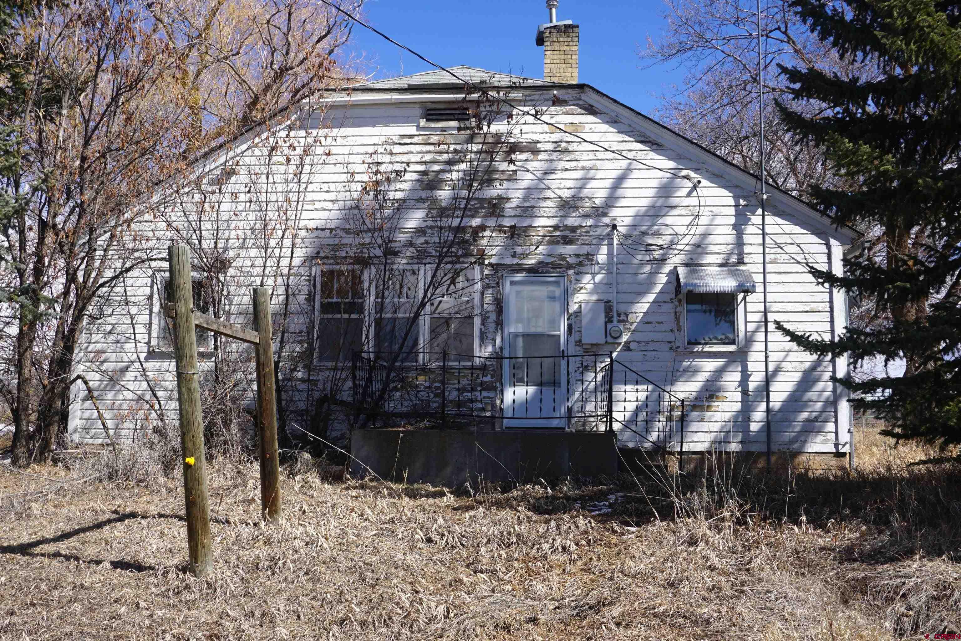 19235 2325th Road Cedaredge, CO 81413 - Photo 22 of 34 a building with trees in front of it