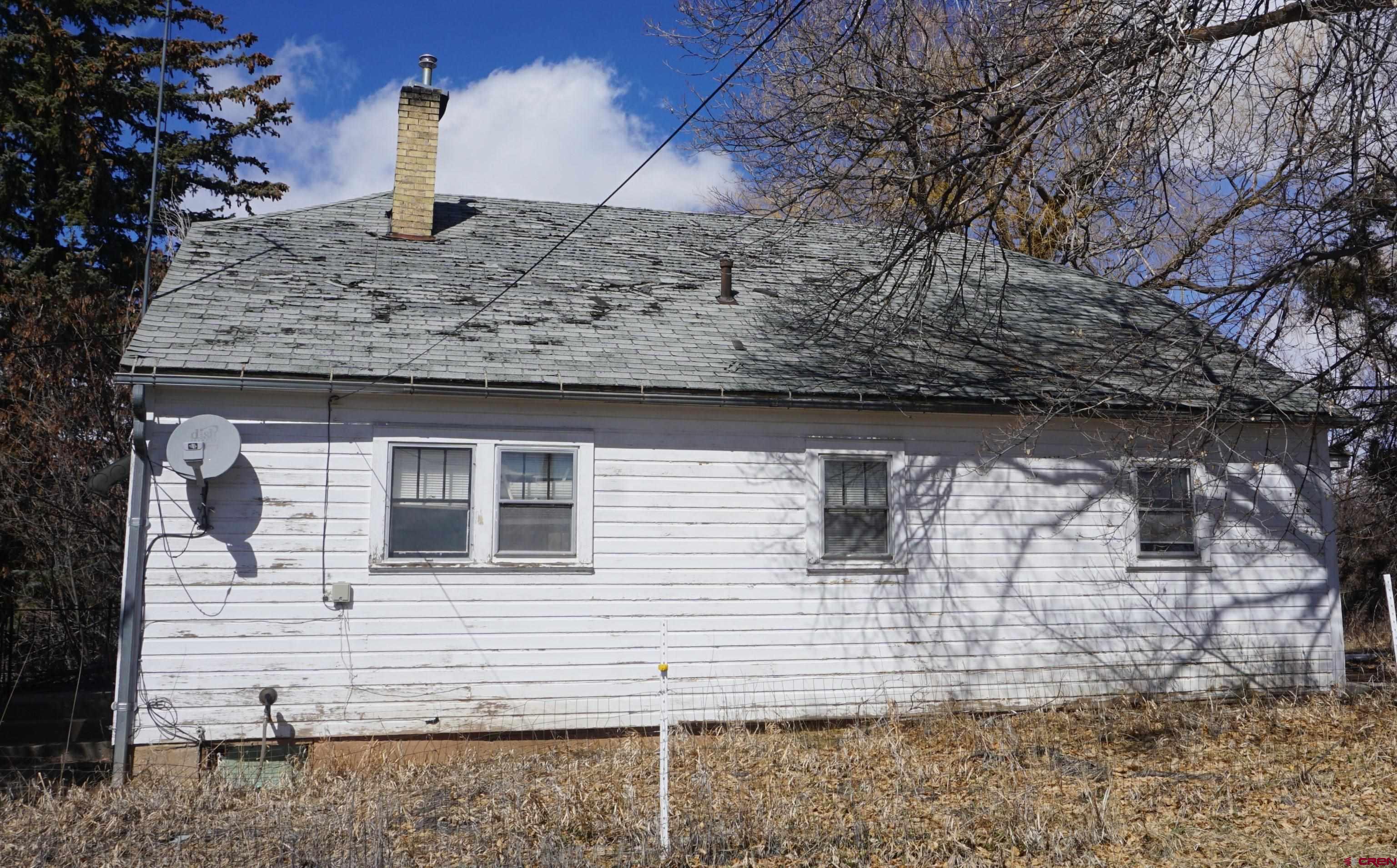 19235 2325th Road Cedaredge, CO 81413 - Photo 23 of 34 a front view of a house with mountain
