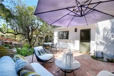 a outdoor living space with furniture and a umbrella