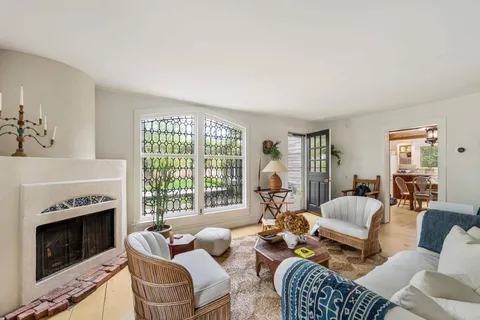 a living room with furniture a fireplace and a flat screen tv