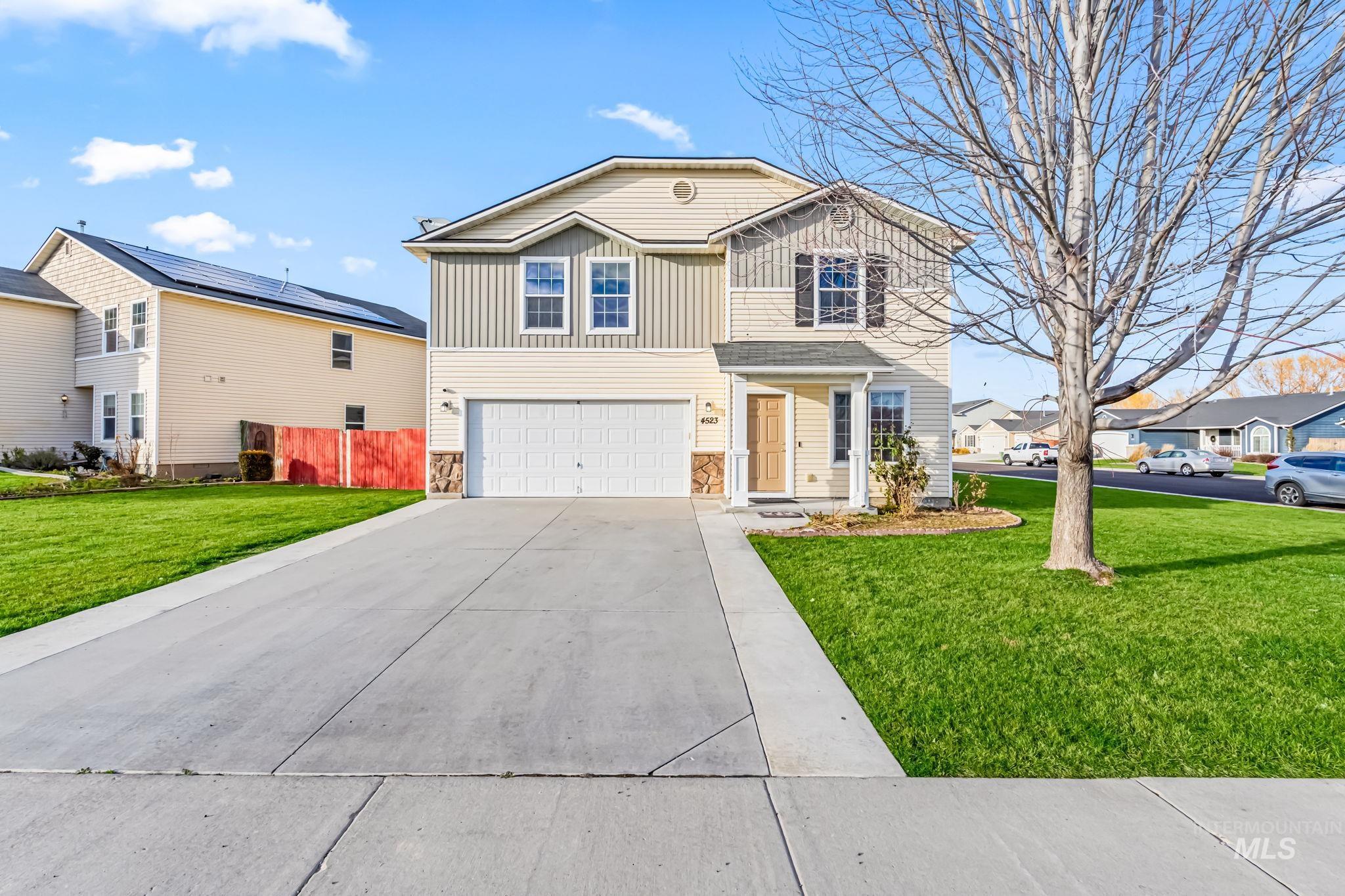 4523 Duke Street Caldwell, ID 83607 - Photo 1 of 27 Traditional-style home with a front yard, stone siding, driveway, a garage, and board and batten siding