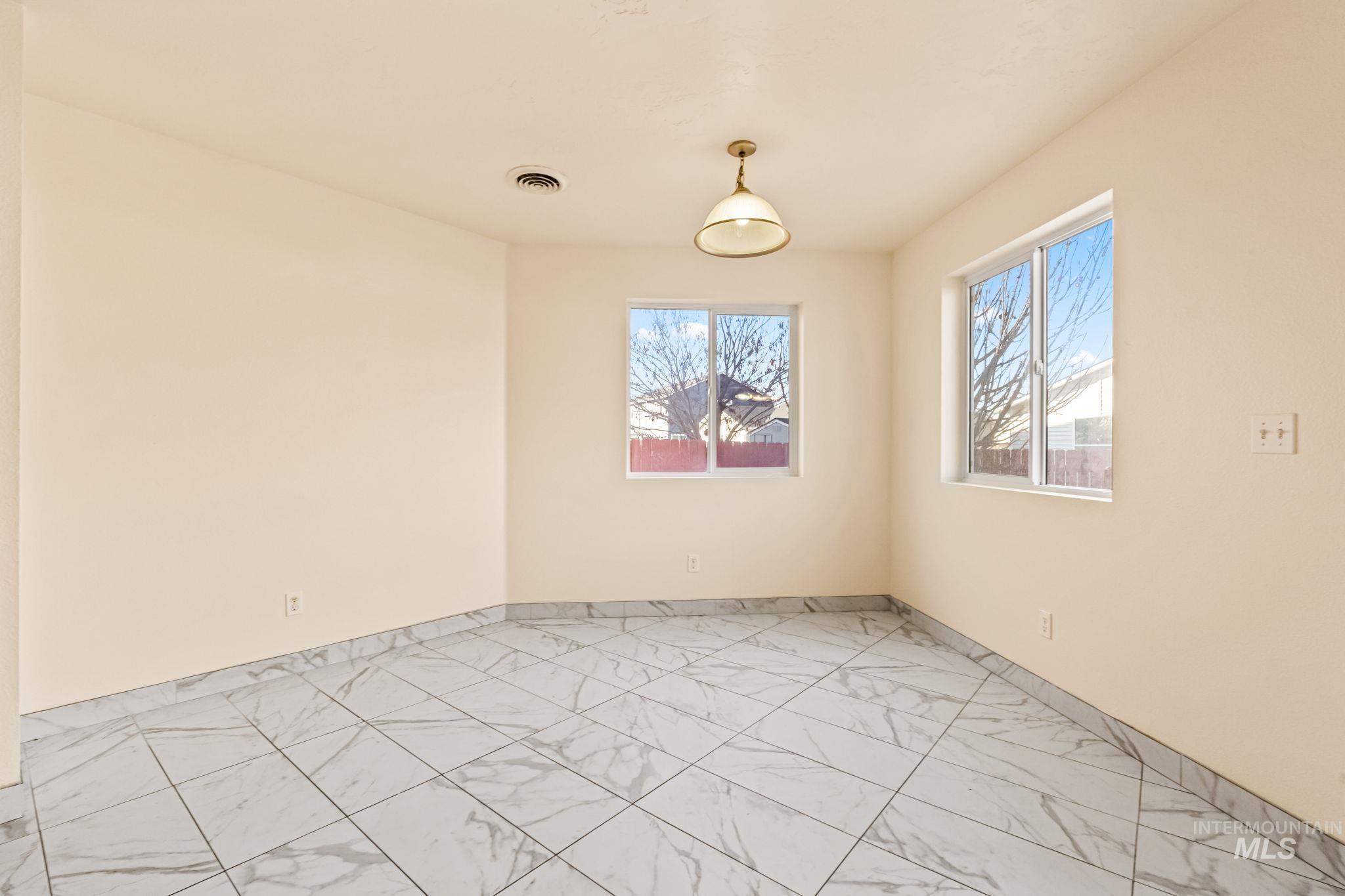 4523 Duke Street Caldwell, ID 83607 - Photo 11 of 27 Spare room featuring light marble finish floors and baseboards