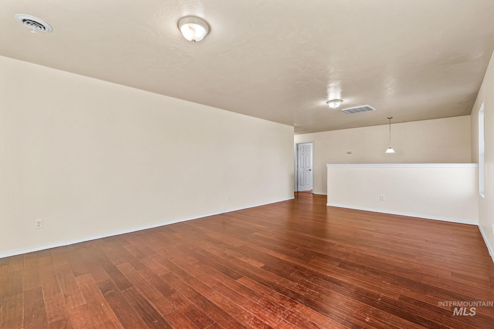4523 Duke Street Caldwell, ID 83607 - Photo 15 of 27 Empty room with dark wood-style flooring and baseboards