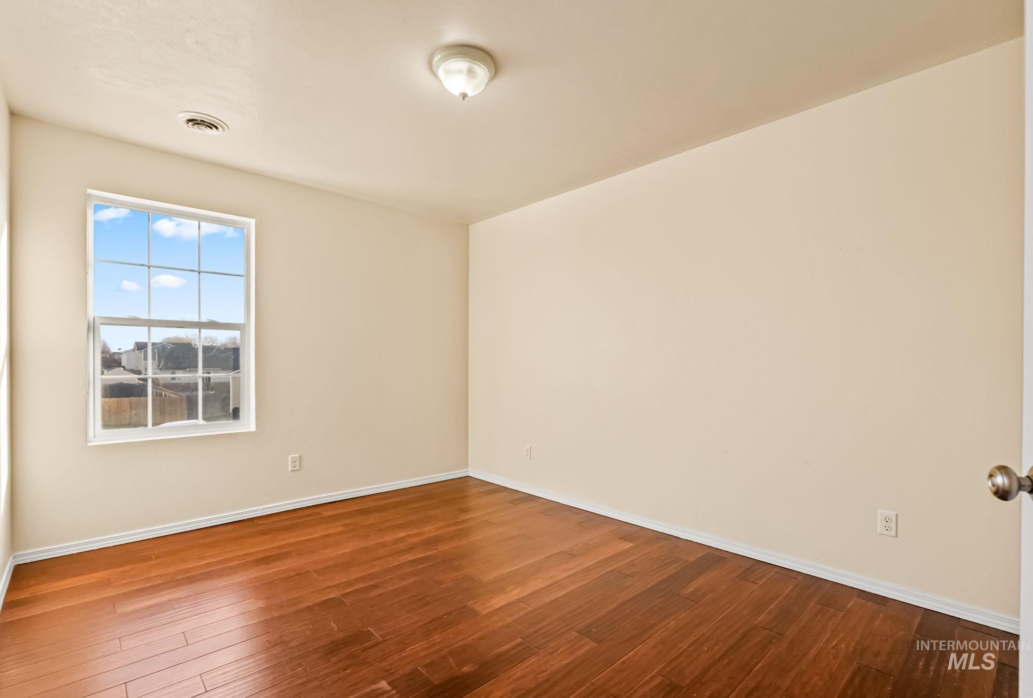 4523 Duke Street Caldwell, ID 83607 - Photo 22 of 27 Unfurnished room featuring wood-type flooring and baseboards