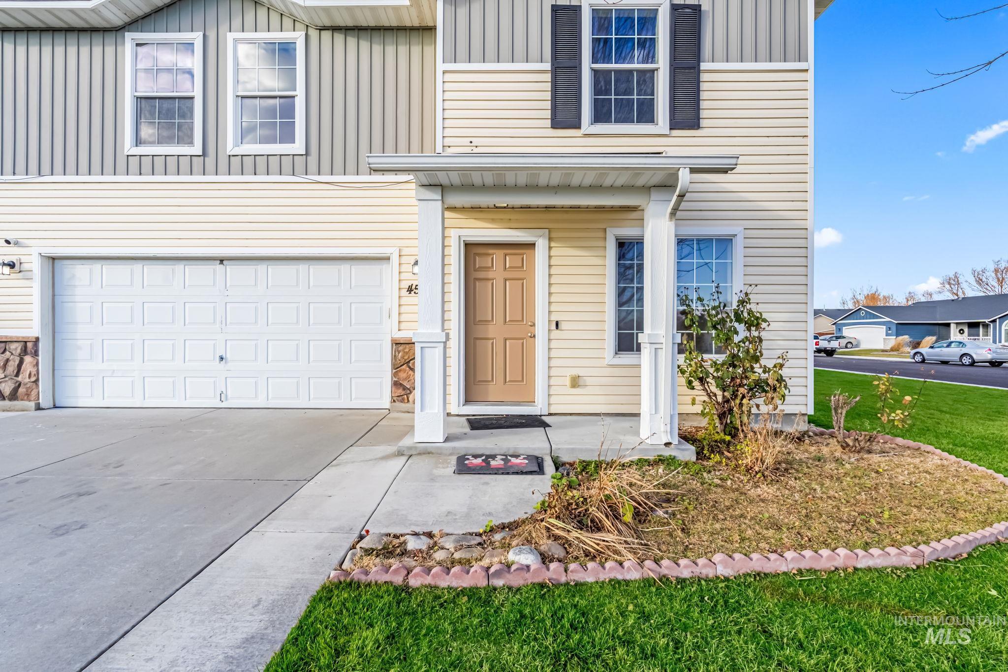 4523 Duke Street Caldwell, ID 83607 - Photo 3 of 27 View of front facade with board and batten siding, concrete driveway, an attached garage, and stone siding