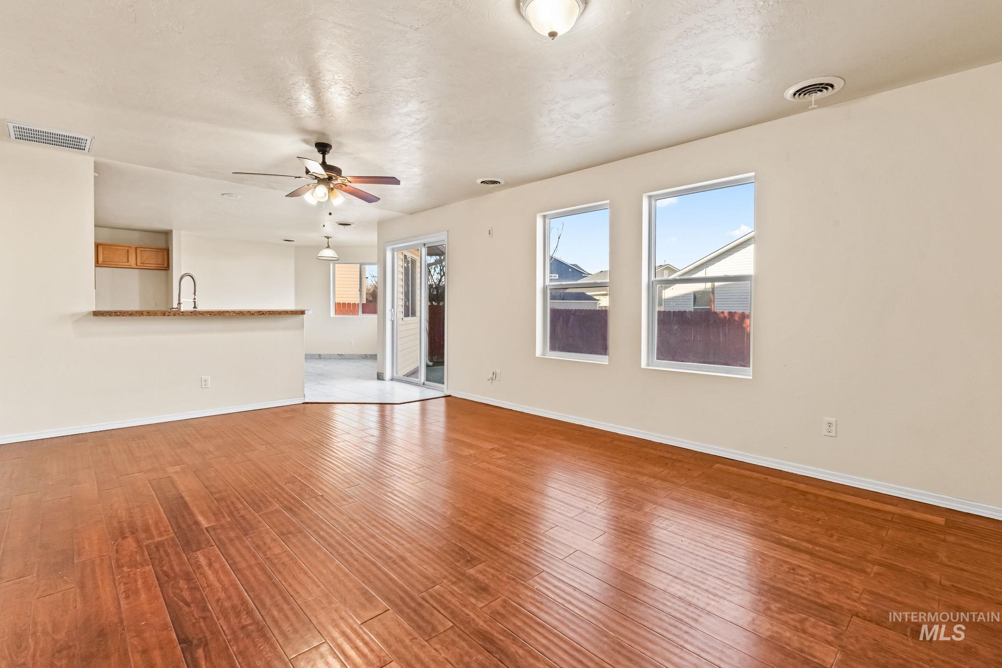 4523 Duke Street Caldwell, ID 83607 - Photo 7 of 27 Unfurnished living room with light wood-style flooring and ceiling fan