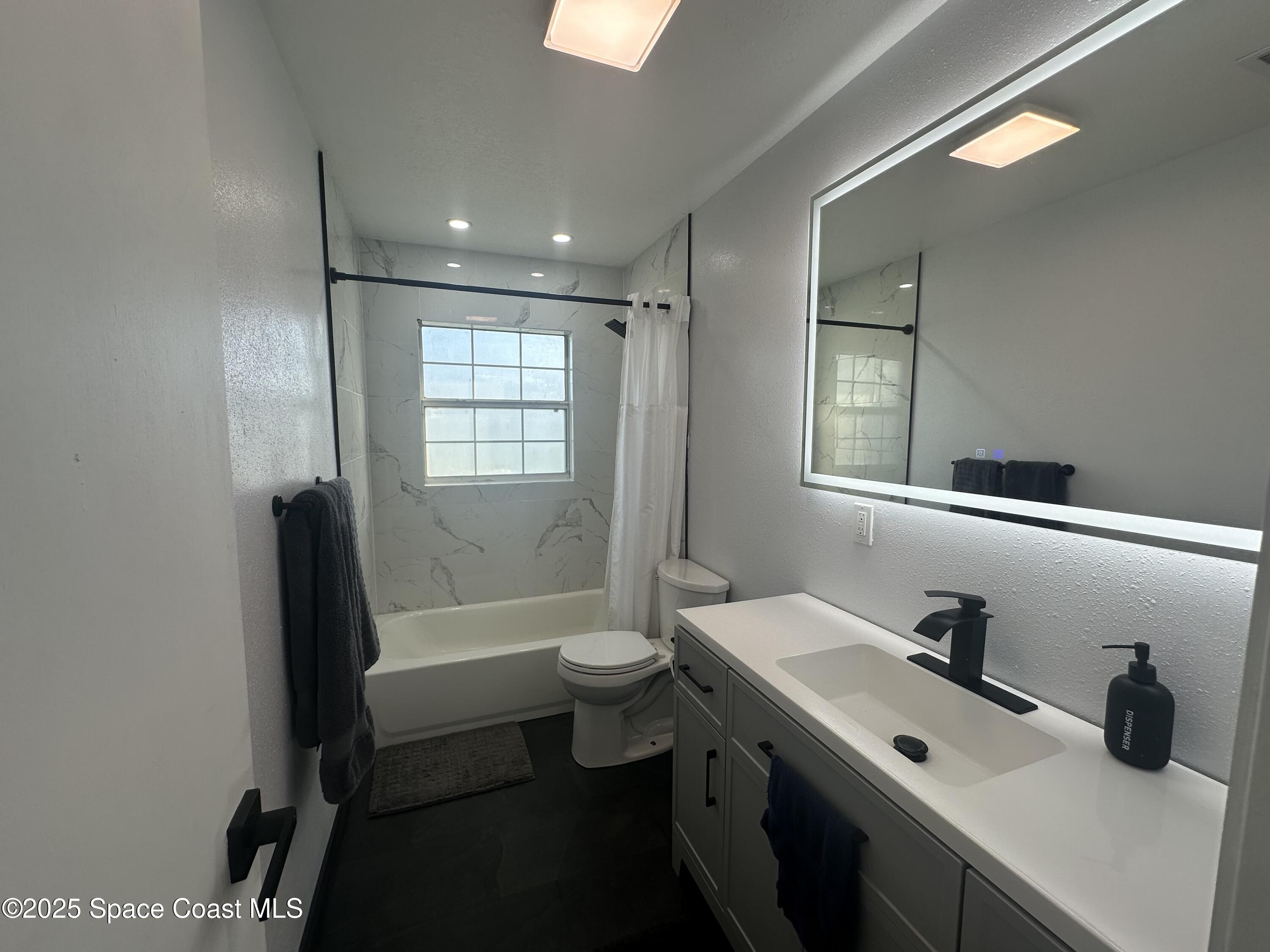 3782 Catalina Drive Cocoa, FL 32926 - Photo 16 of 17 a bathroom with a double vanity sink toilet and shower