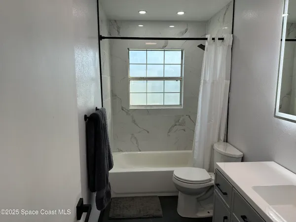 a bathroom with a toilet a sink and bathtub