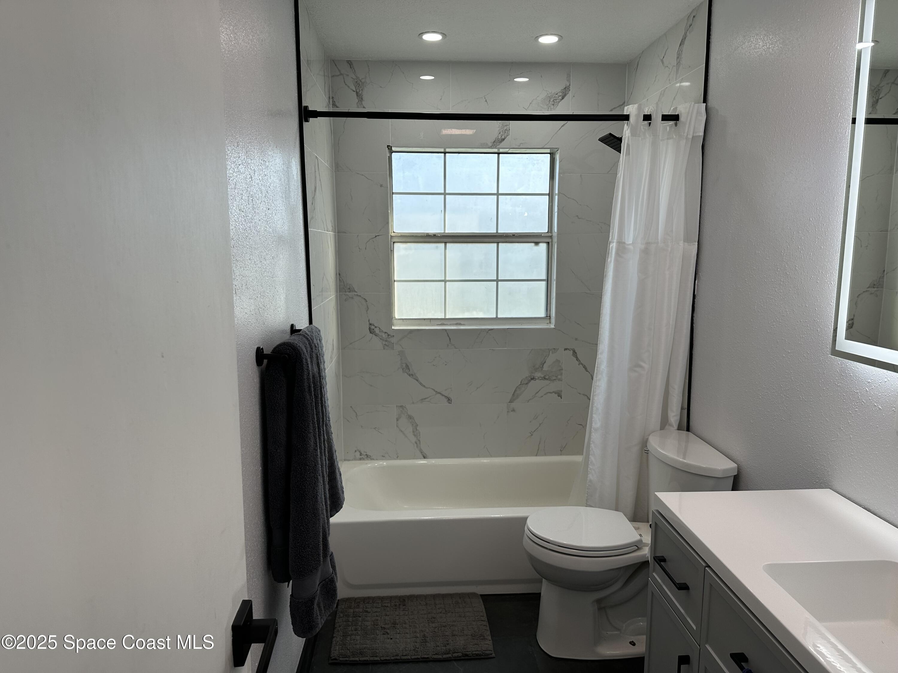 3782 Catalina Drive Cocoa, FL 32926 - Photo 17 of 17 a bathroom with a toilet a sink and bathtub