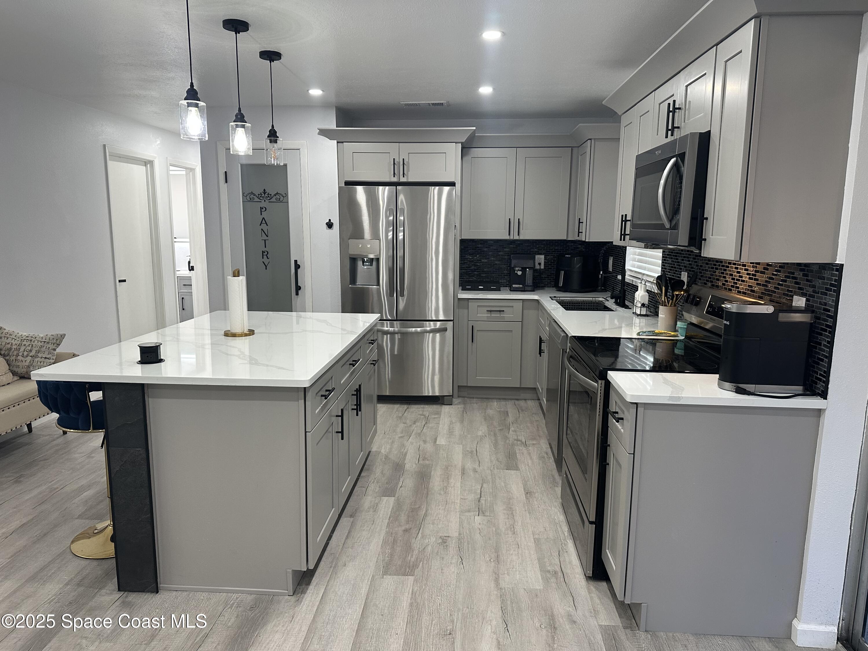 3782 Catalina Drive Cocoa, FL 32926 - Photo 6 of 17 a kitchen with refrigerator and cabinets