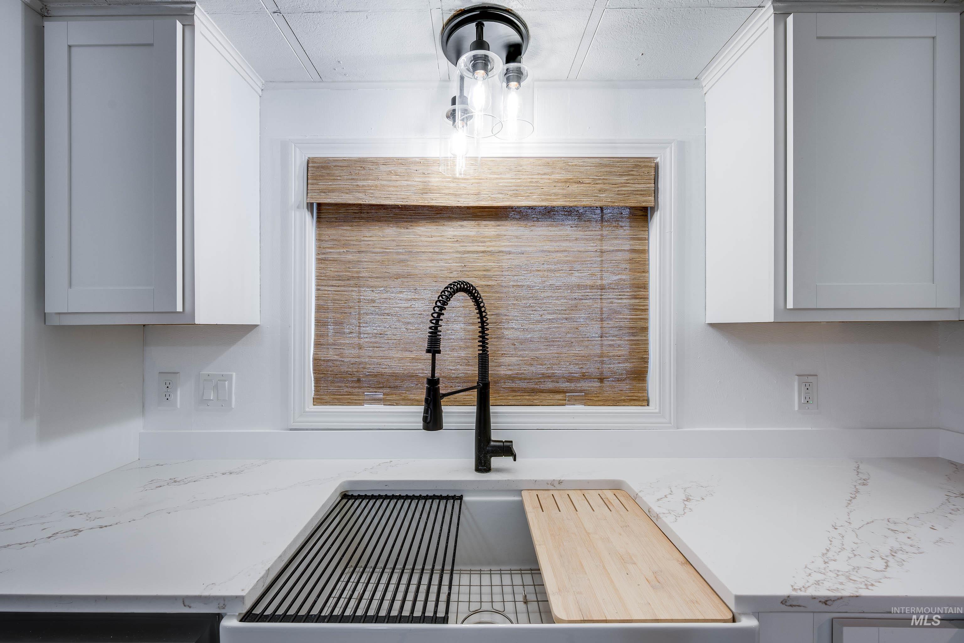 411 North Almon Street, Unit 304 Moscow, ID 83843 - Photo 9 of 21 Kitchen view of light stone countertops and white cabinetry