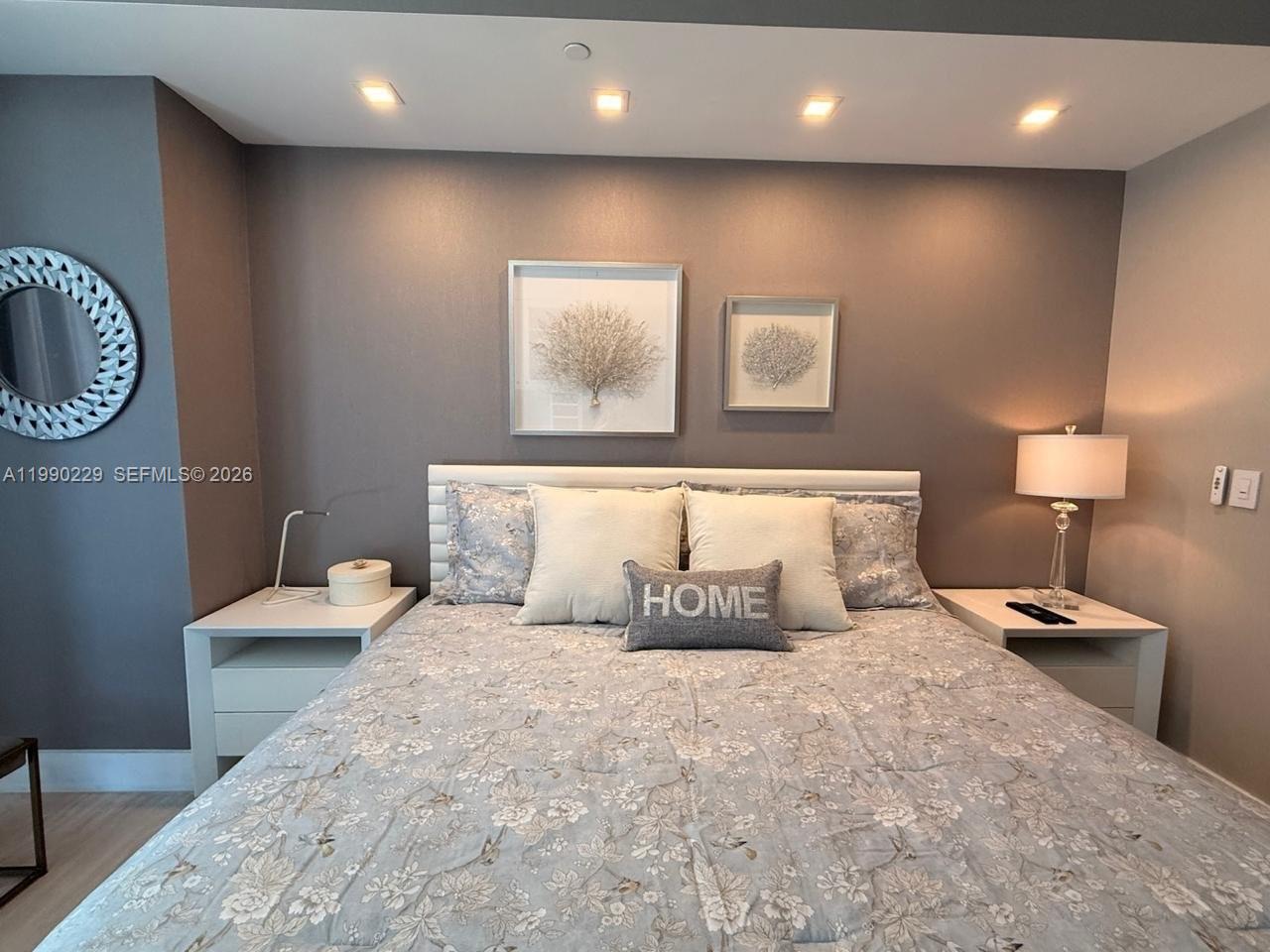 45 Southwest 9th Street, Unit 1401 Miami, FL 33130 - Photo 13 of 17 a bedroom with a bed and painting on the wall