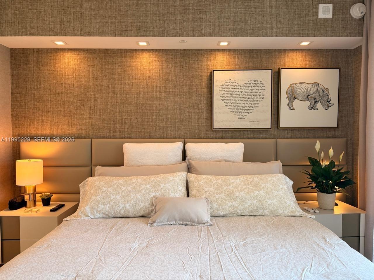 45 Southwest 9th Street, Unit 1401 Miami, FL 33130 - Photo 8 of 17 a bedroom with a large bed and a couch