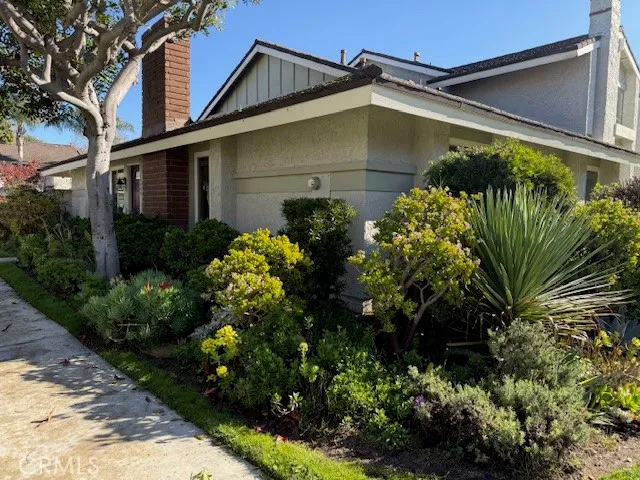 an aerial view of a house with a yard and potted plants