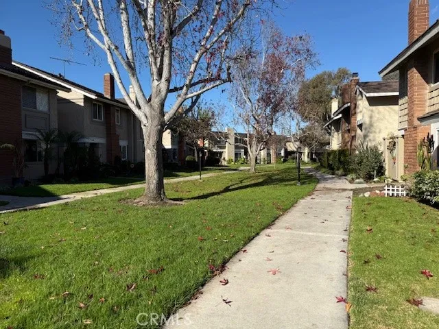 an aerial view of a city with lots of residential buildings ocean and mountain view in back