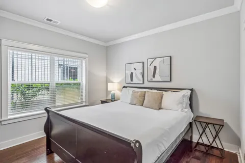 a large bed sitting in a bedroom next to a window